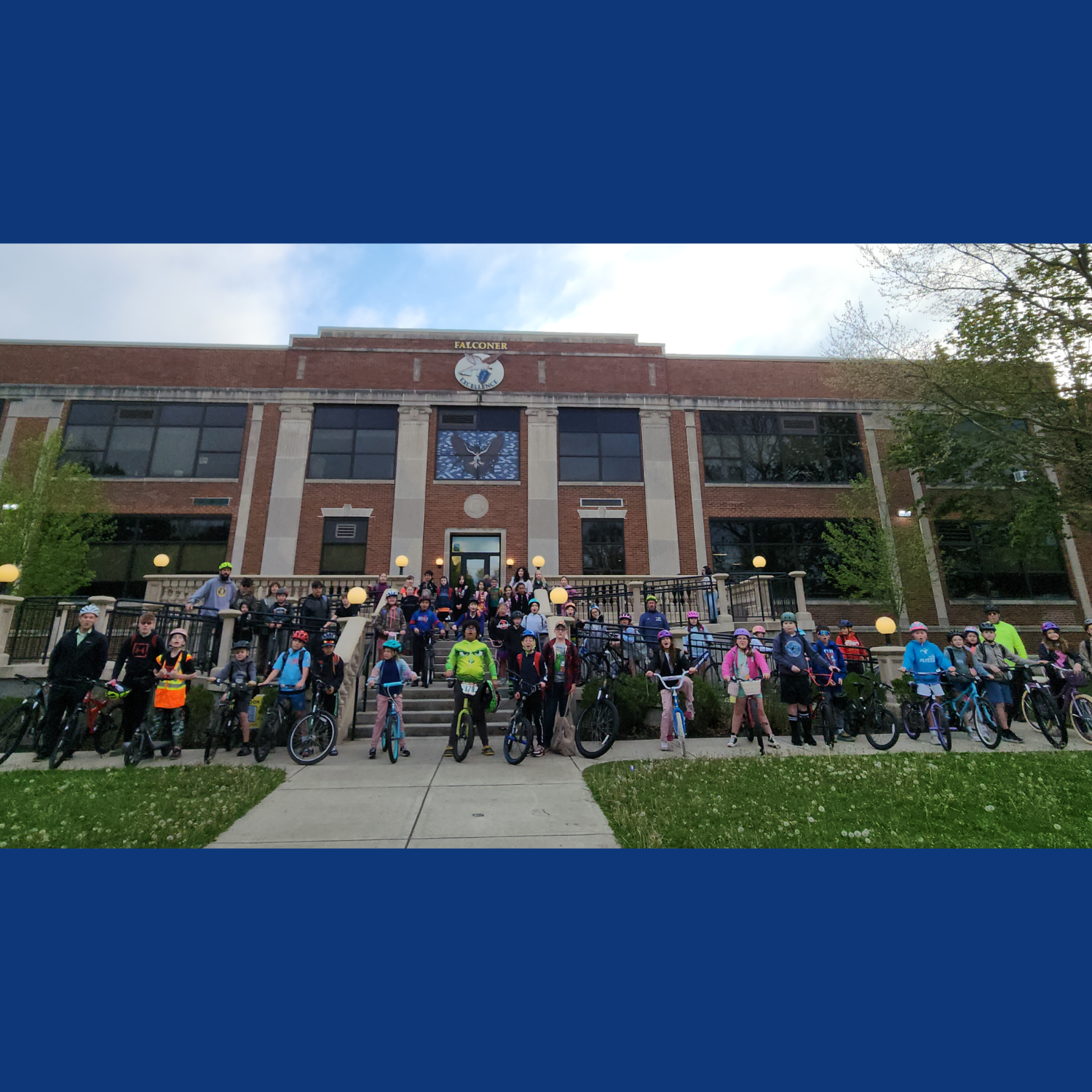  Students on bicycles in front of the entrance of Falconer Middle High School